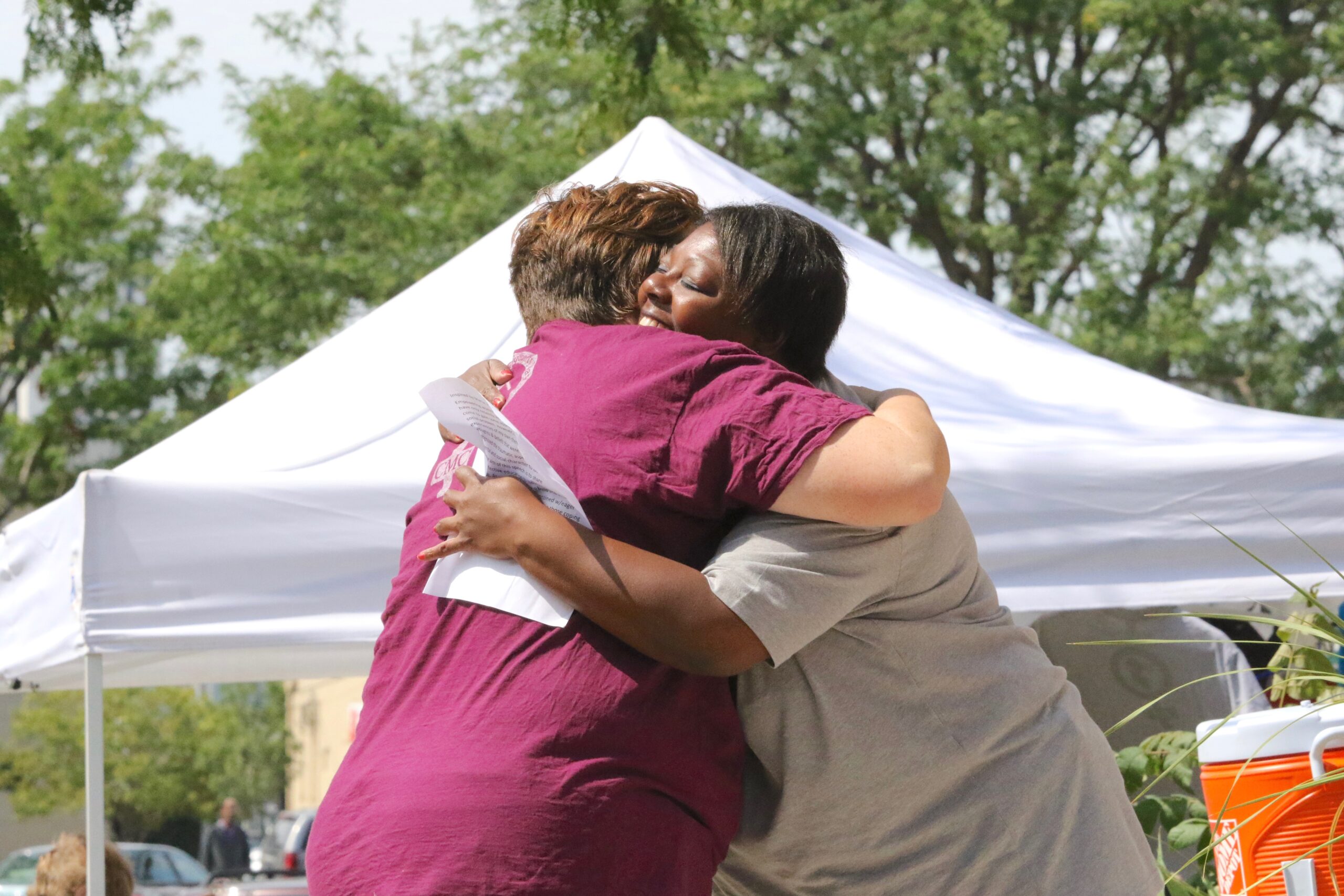 Two award winners hug at Catherine McAuley Center's Women's Equality Day 2018