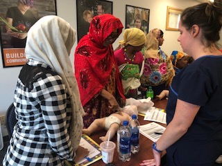 refugee women practice skills during a cpr class