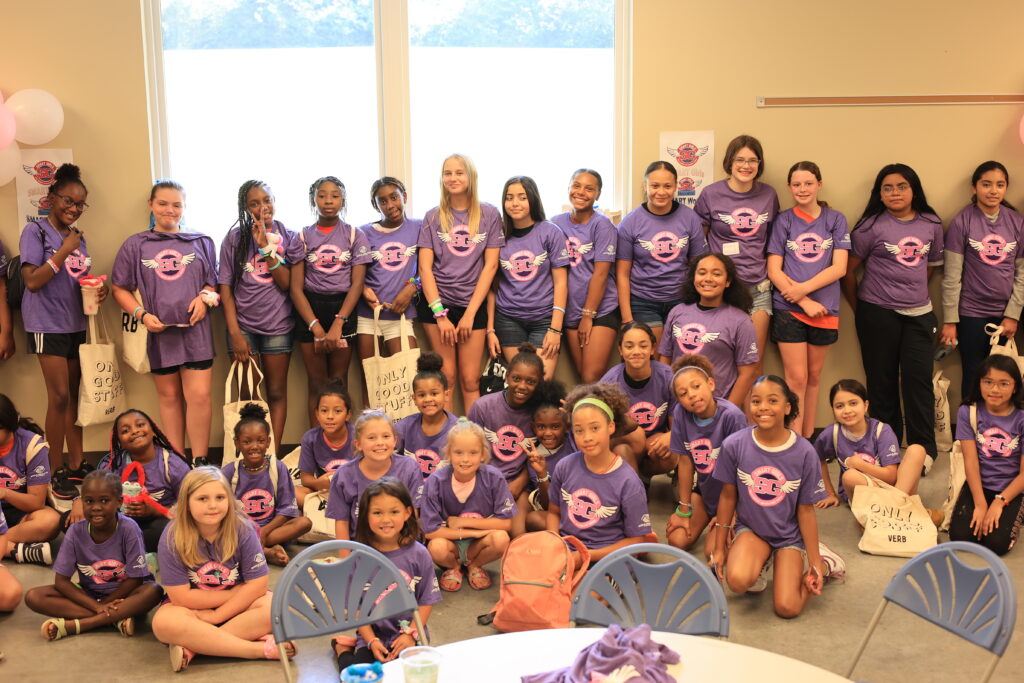 All participants in the Boys & Girls Club SMART Girls program pose together for a group photo while wearing matching t-shirts