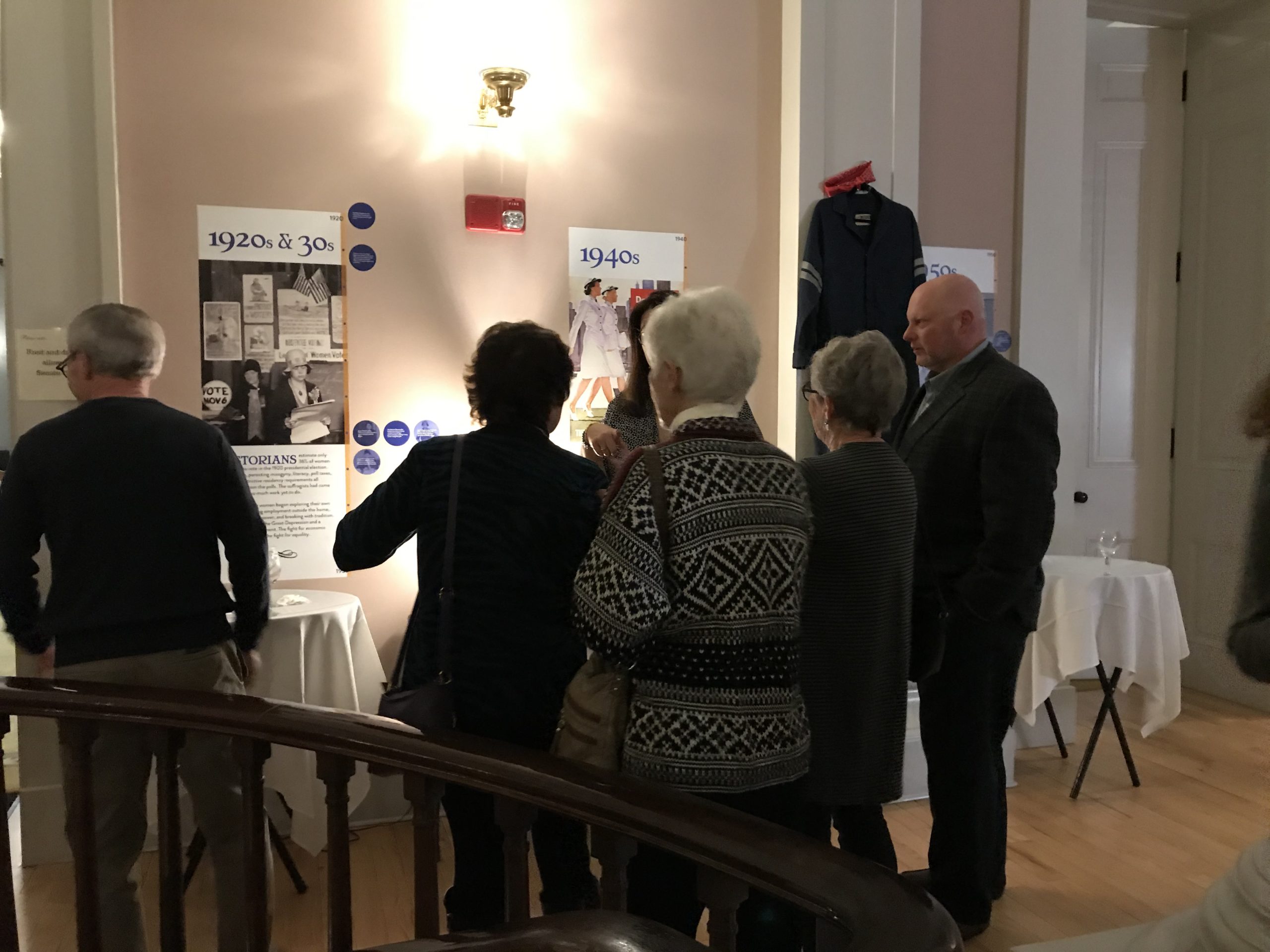 Attendees gather around exhibit pieces at the 19th Amendment Centennial