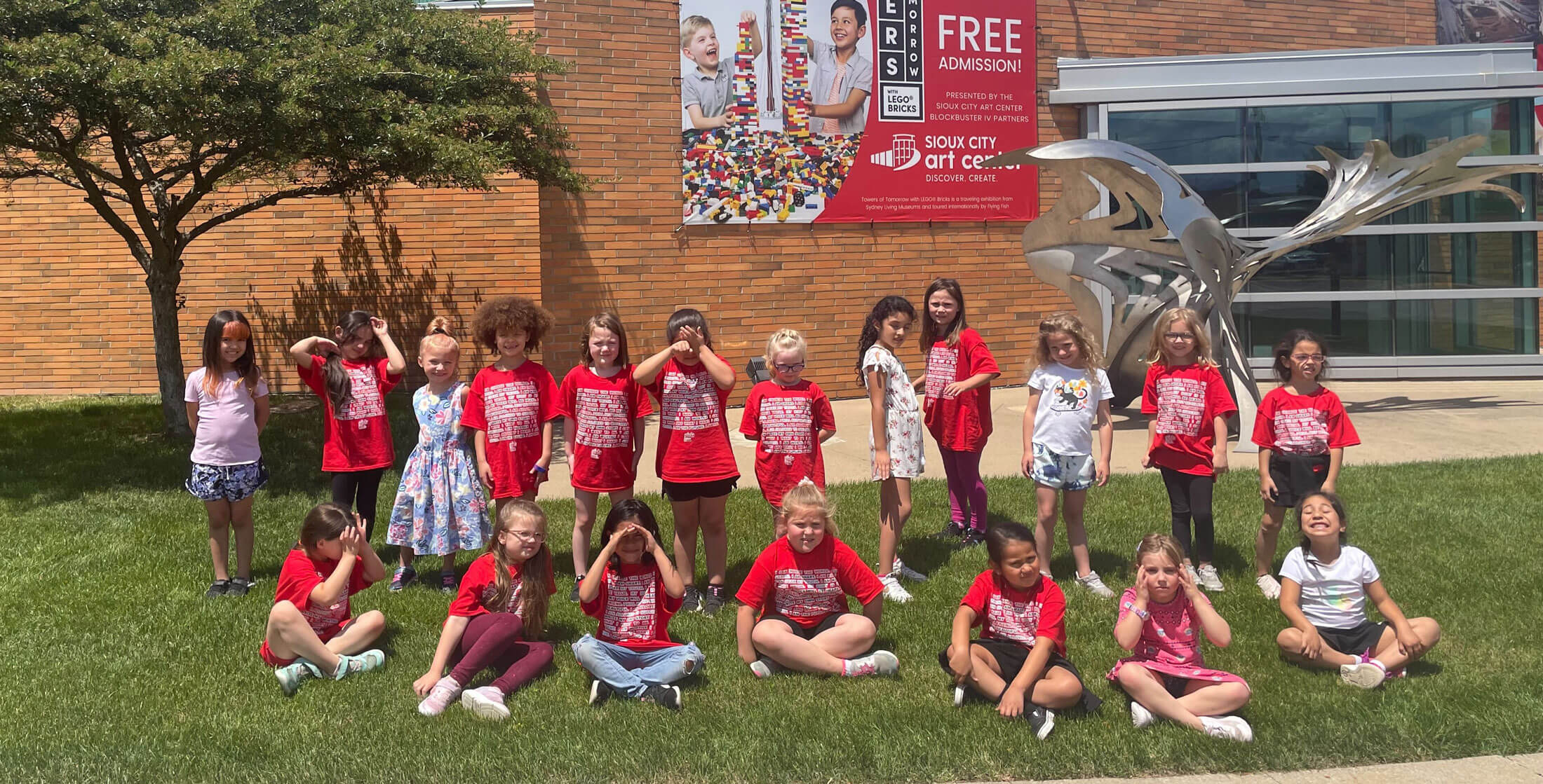 A group of girls participating in The Girls Inc Summer 2022 Program stands outside Sioux City Art Center