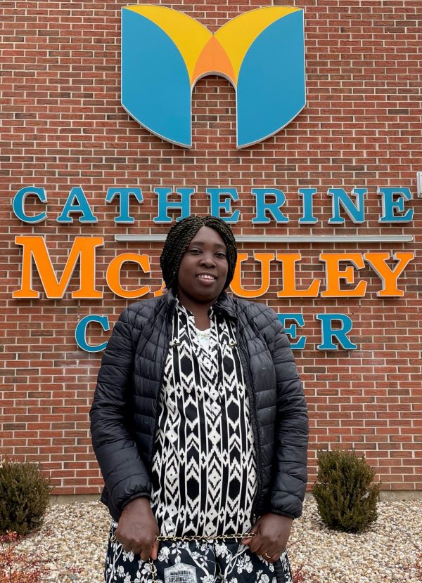 Alpho Tshamala of Cedar Rapids stands in front of the Catherine McAuley Center
